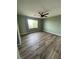 Well-lit bedroom with hardwood floors, window and neutral-colored walls at 5709 Nobleton Ct, North Las Vegas, NV 89081