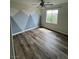 Bright bedroom featuring a ceiling fan, mountain mural, and light-colored hardwood floors at 5709 Nobleton Ct, North Las Vegas, NV 89081