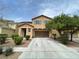 Two-story home featuring a two car garage, neutral color palette and drought resistant landscaping at 5709 Nobleton Ct, North Las Vegas, NV 89081