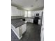 Charming kitchen with white cabinets, black appliances, granite countertops, and tiled floors at 5709 Nobleton Ct, North Las Vegas, NV 89081