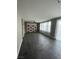 Open living space with dark tile floors, neutral walls, a built in entertainment center, and large windows at 5709 Nobleton Ct, North Las Vegas, NV 89081
