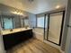 A spacious main bathroom features double sinks, a separate tub, and a shower with black trim at 5709 Nobleton Ct, North Las Vegas, NV 89081