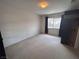 Bedroom features carpet floors and a large window at 577 Leap Frog Ave, Las Vegas, NV 89183