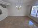 Elegant dining room with a chandelier, tile flooring, and ample natural light at 577 Leap Frog Ave, Las Vegas, NV 89183