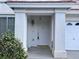 Close-up of the front door with detailed molding, hardware, and a textured white exterior at 577 Leap Frog Ave, Las Vegas, NV 89183