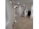 Bright hallway with tile flooring, staircase and access to other areas of the home at 577 Leap Frog Ave, Las Vegas, NV 89183