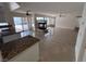 Open-concept living space featuring a fireplace, tile floors, and access to the backyard at 577 Leap Frog Ave, Las Vegas, NV 89183