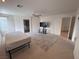 Spacious main bedroom with carpet flooring, ceiling fan, and adjacent bathroom access at 577 Leap Frog Ave, Las Vegas, NV 89183