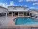 Backyard featuring a sparkling pool, covered patio, and ample space for outdoor activities at 577 Leap Frog Ave, Las Vegas, NV 89183