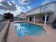 Inviting backyard with a refreshing pool and a covered patio, perfect for outdoor relaxation and entertainment at 577 Leap Frog Ave, Las Vegas, NV 89183