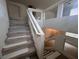 Carpeted staircase with white railing ascends to the upper level of the home at 577 Leap Frog Ave, Las Vegas, NV 89183
