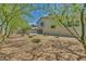A spacious backyard with rock landscaping, patio, barbecue, and second-story balcony at 6815 Garden Grove Ave, Las Vegas, NV 89103