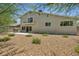 A spacious backyard with rock landscaping, patio, barbecue, and second-story balcony at 6815 Garden Grove Ave, Las Vegas, NV 89103