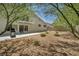 A spacious backyard with rock landscaping, patio, barbecue, and second-story balcony at 6815 Garden Grove Ave, Las Vegas, NV 89103