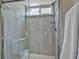 Updated bathroom featuring a glass-enclosed shower with modern fixtures and decorative tile at 6815 Garden Grove Ave, Las Vegas, NV 89103