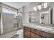 Bathroom featuring granite countertops, a wooden vanity, and a walk-in shower with glass doors at 6815 Garden Grove Ave, Las Vegas, NV 89103