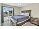 Comfortable bedroom with sliding glass door to a private balcony and stylish furnishings at 6815 Garden Grove Ave, Las Vegas, NV 89103
