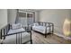 Bright bedroom featuring two twin beds, wood-look flooring, and a window allowing ample natural light at 6815 Garden Grove Ave, Las Vegas, NV 89103