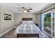 A bedroom featuring wood-look flooring and a sliding glass door to a balcony at 6815 Garden Grove Ave, Las Vegas, NV 89103
