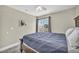 Bright bedroom featuring a large bed and sliding glass door that leads to a private balcony at 6815 Garden Grove Ave, Las Vegas, NV 89103