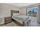 Comfortable bedroom with a ceiling fan, wood-look flooring, and access to a private balcony at 6815 Garden Grove Ave, Las Vegas, NV 89103