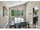 Dining area with a modern light fixture, a large window, and dark wood flooring at 6815 Garden Grove Ave, Las Vegas, NV 89103
