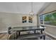 Dining area with a modern light fixture and view to the front yard at 6815 Garden Grove Ave, Las Vegas, NV 89103