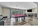 Spacious game room with pool table, fireplace, and sliding door to the yard at 6815 Garden Grove Ave, Las Vegas, NV 89103