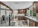 Spacious kitchen with granite counters, stainless steel appliances, and dark wood cabinets at 6815 Garden Grove Ave, Las Vegas, NV 89103