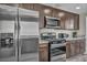 Modern kitchen featuring stainless steel appliances and granite countertops at 6815 Garden Grove Ave, Las Vegas, NV 89103