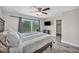A spacious main bedroom features wood-look flooring and a sliding glass door to a balcony at 6815 Garden Grove Ave, Las Vegas, NV 89103