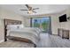 A spacious main bedroom has wood-look flooring and a sliding glass door to a balcony at 6815 Garden Grove Ave, Las Vegas, NV 89103