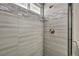 Shower featuring gray and white tilework and a glass door enclosure at 6815 Garden Grove Ave, Las Vegas, NV 89103