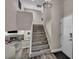 Staircase view with gray wood floor, with a fireplace and pool table on the right at 6815 Garden Grove Ave, Las Vegas, NV 89103