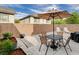 Cozy backyard with an outdoor dining table, chairs, barbecue, and lounge chairs for relaxing at 688 Monument Point St, Henderson, NV 89002
