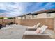 Spacious backyard featuring lounge chairs, an outdoor dining table and a barbecue grill at 688 Monument Point St, Henderson, NV 89002