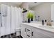 Bright bathroom featuring a white vanity, and shower/tub with white shower curtain at 688 Monument Point St, Henderson, NV 89002
