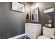 Charming powder room with black and white accents, decorative mirror, and patterned tile at 688 Monument Point St, Henderson, NV 89002