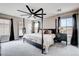 Cozy bedroom with a four poster bed and large windows at 688 Monument Point St, Henderson, NV 89002