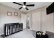 Neutral Bedroom featuring a crib, mounted TV, closet and a view into a hallway at 688 Monument Point St, Henderson, NV 89002