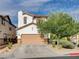 Two-story home with a neutral color scheme, well-maintained landscaping, and an attached two-car garage at 688 Monument Point St, Henderson, NV 89002