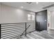 Hallway with railing, two windows, and a decorative wall with a doorway to a laundry room at 688 Monument Point St, Henderson, NV 89002