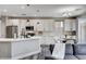 Contemporary kitchen with white cabinets, stainless steel appliances, and a center island with barstool seating at 688 Monument Point St, Henderson, NV 89002