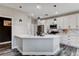 Bright kitchen island with white countertops, pendant lighting, and stainless steel appliances at 688 Monument Point St, Henderson, NV 89002