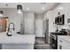 Modern kitchen showcasing white cabinets, a stainless steel gas range, and a kitchen island with a sink at 688 Monument Point St, Henderson, NV 89002