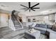 Open-concept living area with stairs to the second floor and seamless transition to the modern, white kitchen at 688 Monument Point St, Henderson, NV 89002