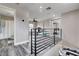 Upstairs loft area with railing, adjacent bath, and neutral color palette for versatile use at 688 Monument Point St, Henderson, NV 89002