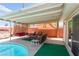 Patio with outdoor seating near pool featuring a covered awning for shade at 704 N Wallace Dr, Las Vegas, NV 89107
