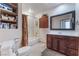 Bright bathroom featuring a shower-over-tub, storage, and a stylish vanity with plenty of counter space at 704 N Wallace Dr, Las Vegas, NV 89107
