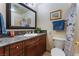Cozy bathroom featuring a granite countertop vanity and framed mirror at 704 N Wallace Dr, Las Vegas, NV 89107